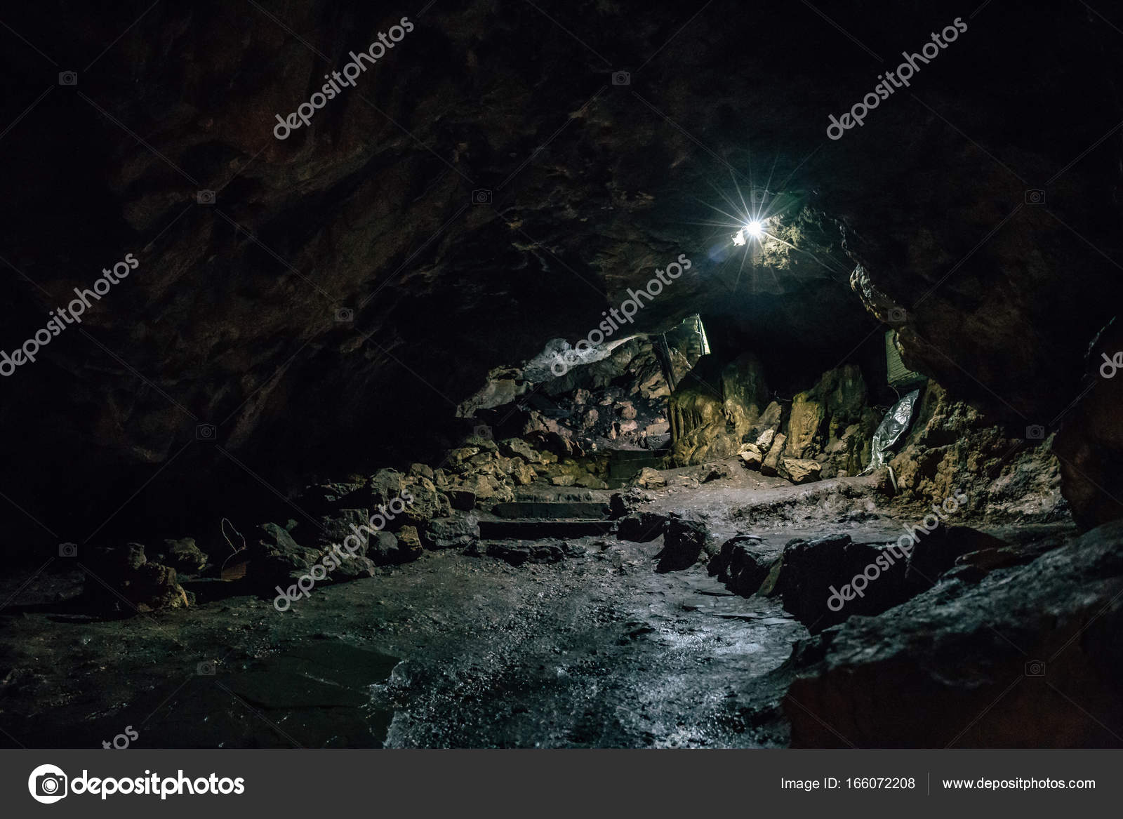 Exit from big dark scary underground cave in form of tunnel Stock Photo by  ©DedMityay 166072208