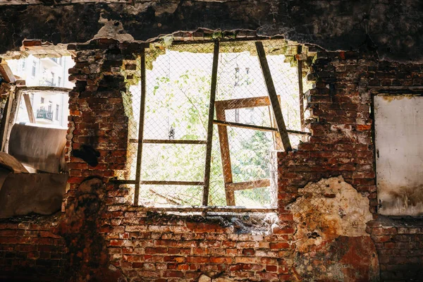 Inside ruined abandoned house building after disaster, war, earthquake or other natural cataclysm. Big broken window with rubbish — Stock Photo, Image