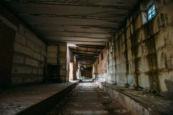 Dark scary corridor in abandoned industrial ruined brick factory, creepy interior, perspective — Stock Photo, Image