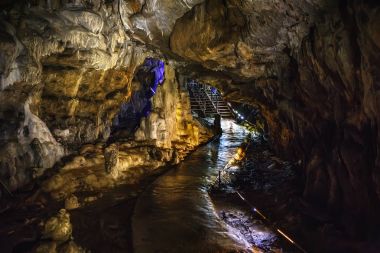 Underground creepy tunnel in dark cave or limestone grotto, speleology nature corridor in Adygeya mountains clipart