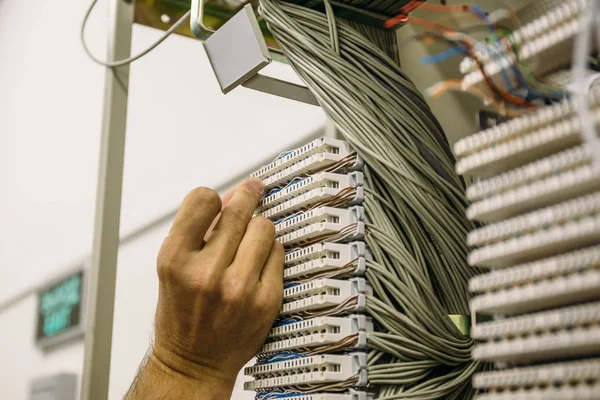 Ingegnere lavora in data center con cavi e interruttori — Foto Stock