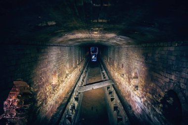 Abandoned underground sewer brick tunnel, dark dirty industrial corridor, tube perspective view clipart