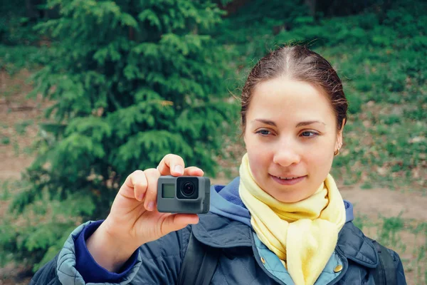 Young woman with action camera