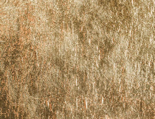 Gold shiny foil texture background or pattern