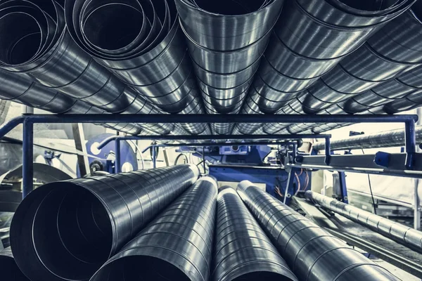 Stack of steel or metal pipes or round tubes as industrial background with perspective