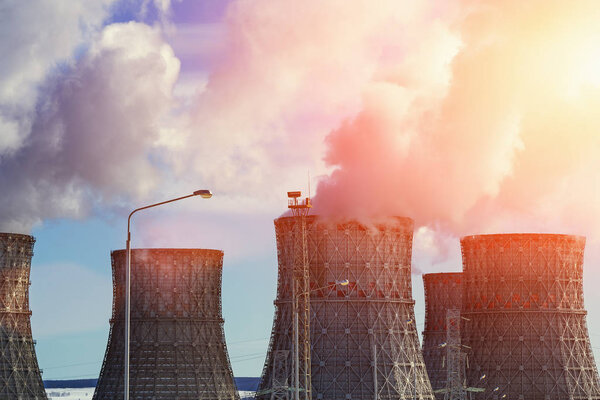 Nuclear Power Plant, clouds of thick smoke from cooling towers or chimneys, atomic nuclear energy concept