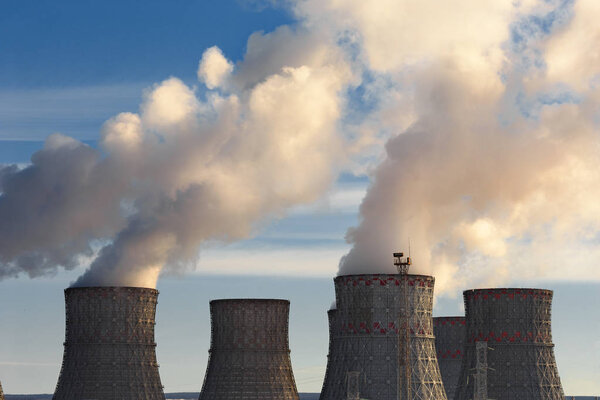 Nuclear Power Plant, clouds of thick smoke from cooling towers or chimneys, atomic nuclear energy concept