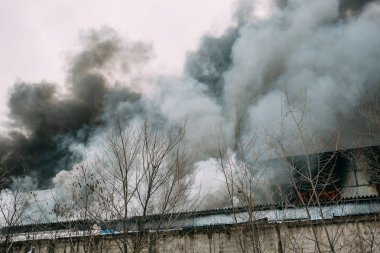 Bir endüstriyel depo veya fabrika, çok duman ve alevler ateş
