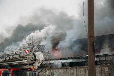 Bir endüstriyel depo veya fabrika, çok duman ve alevler ateş