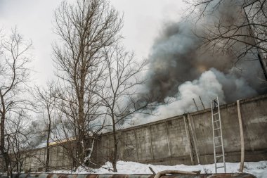 Bir endüstriyel depo veya fabrika, çok duman ve alevler ateş