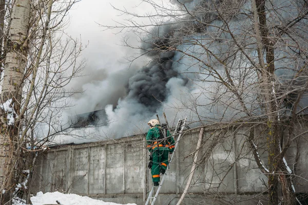 Fire in an industrial warehouse or Factory, lots of smoke and flames