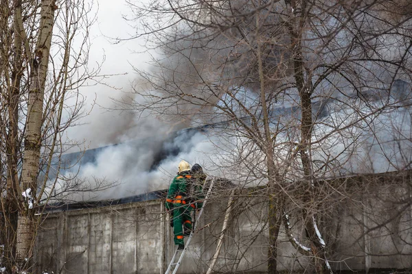 Fire in an industrial warehouse or Factory, lots of smoke and flames