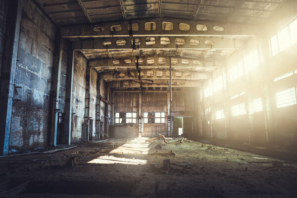 Abandoned ruined industrial factory building, corridor view with perspective, ruins and demolition concept, toned