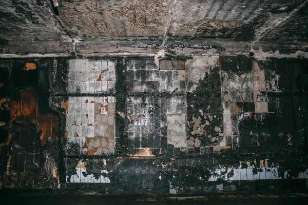 Burned underground pedestrian crossing after a fire or terrorist attack, walls in soot and smoke
