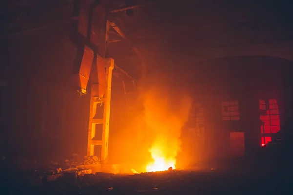Kebakaran di aula besar pabrik atau gudang di malam hari. Api besar merah dan kuning. Bencana di gedung industri terbakar — Stok Foto