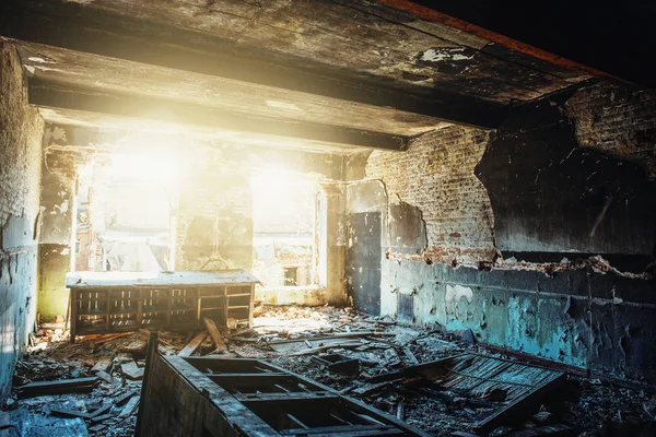 Ruïnes van de oude verlaten gebouw, beschadigd in de oorlog, in verwoeste kamer met zonlicht, ramp en verwoesting concept, gebroken muren en meubilair — Stockfoto
