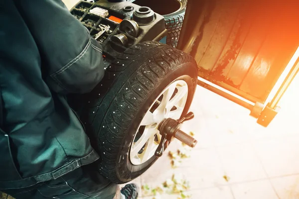 Mobil mekanik menyeimbangkan roda mobil pada mesin komputer penyeimbang dalam layanan perbaikan mobil — Stok Foto