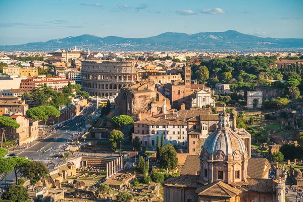 Aerial panorama of Colosseum and Roman Forum in Rome city, Italy. Beautiful cityscape with old famous landmark ruins and historic center of Rome, view from above — Stock Photo, Image