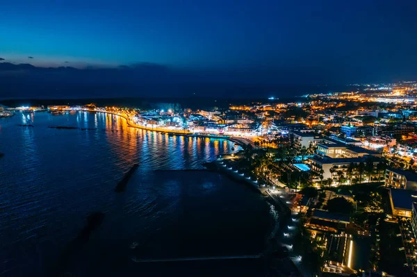Aerial view of Paphos embankment or promenade at night with reflection of city lights in sea water. Famous Cyprus mediterranean resort