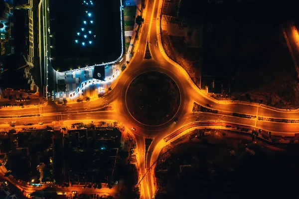 Night city traffic on circle intersection in Paphos, Cyprus. Aerial top down view from drone — Stock Photo, Image