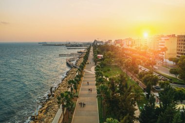 Kıbrıs, Limasol 'da gün batımı. Akdeniz tatil köyü. Limasol şehrinin hava panoramik görüntüsü. Akşamları ahşap rıhtımlar, insansız hava aracı fotoğrafı.