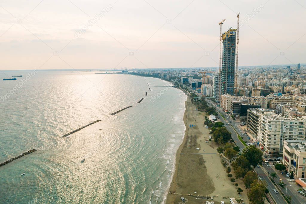 Aerial view of Limassol, Cyprus beach with city views and large new skyscraper under construction