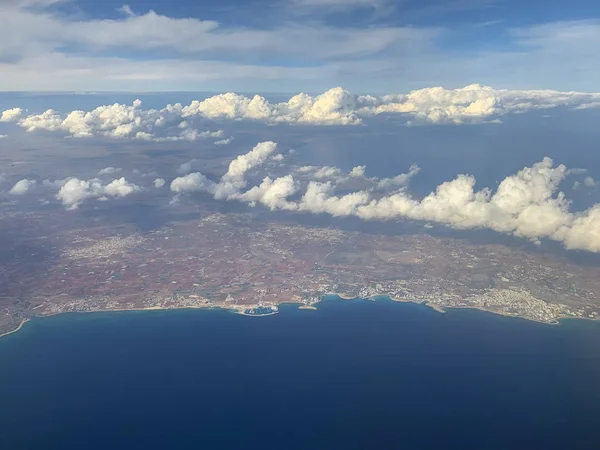 Aerial view of Cyprus island and blue Mediterranean sea from airplane window