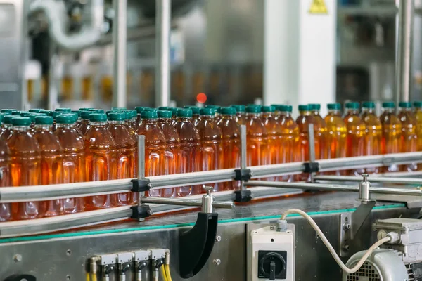 Conveyor belt, juice in bottles on beverage factory, industrial production line