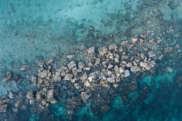 Aerial view of Cyprus sea nature background. Mediterranean sea surface with stones