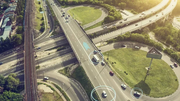 Autonomous Self Driving Cars Concept. Aerial view of cars and buses moving on city intersection and Artificial Intelligence scans road with sensors and control vehicles in traffic. Future