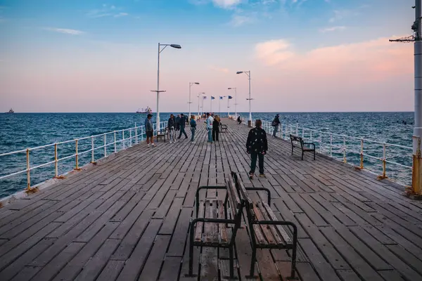 Limassol, Cyprus - November 2019: Wooden pier with people in Limassol, Cyprus, Mediterranean Sea landscape — ストック写真
