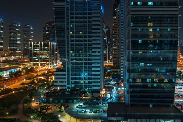 Modern city buildings at night. Typical Dubai high-rise constructions — Stock Photo, Image