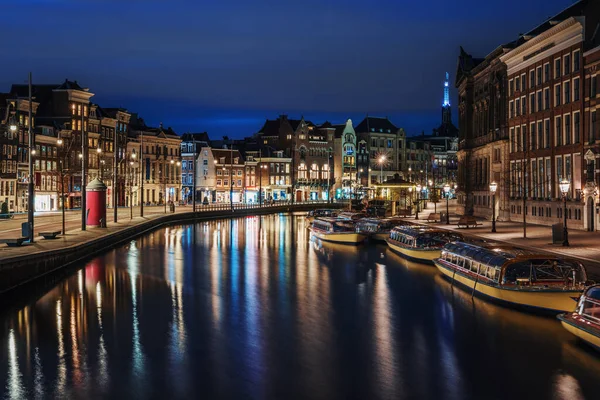 Amsterdam canal, río Amstel con reflexión sobre la iluminación de la ciudad, Países Bajos, ciudad holandesa por la noche — Foto de Stock