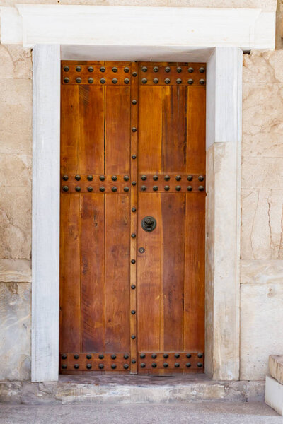 Closed elegant brown wooden door