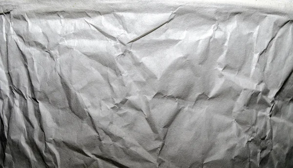 Fragment av skrynkligt papper textur färgade ljusgrå — Stockfoto