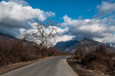Dağın içine gidiyor yol asfalt manzara ağaçlar, köy ve orman yerler geçer. veya günbatımı kırsal yerlerde, Azerbaycan