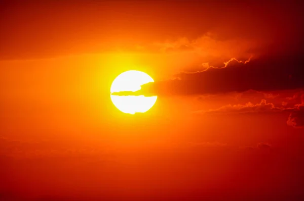 Puesta de sol de verano. El sol poniente en un fondo nublado del cielo —  Fotos de Stock
