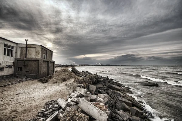 Bela paisagem surreal de casa abandonada e escada na costa rochosa ao pôr-do-sol. Tempo nublado. Mar Cáspio, Azerbaijão , — Fotografia de Stock