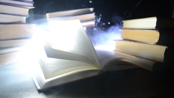 Many old books in a stack. Knoledge concept. Books on a dark background with smoke elements. Bewitched book in center. Glasswatch — Stock Video