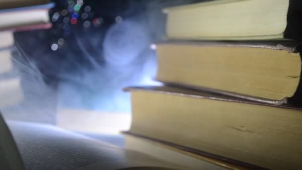 Viele alte Bücher in einem Stapel. knoledge Konzept. Bücher auf dunklem Hintergrund mit Raucherelementen. Zauberhaftes Buch in der Mitte. Glasuhr — Stockvideo