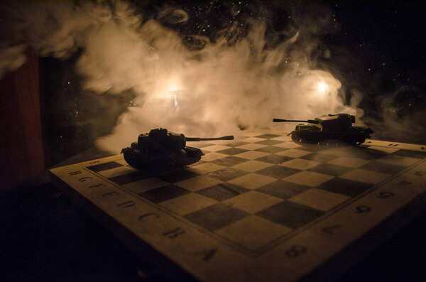 Tanks in the conflict zone. The war in the countryside. Tank silhouette at night. Battle scene.
