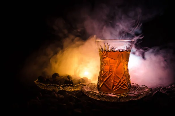 Thé turc azerbaïdjanais en glasse traditionnelle et pot sur fond noir avec lumières et fumée. Coupe traditionnelle Armudu — Photo