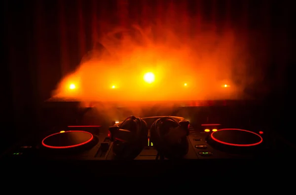 DJ κλώση, ανάμειξη και ξύσιμο σε ένα νυχτερινό κέντρο, τα χέρια του dj τσίμπημα διάφορα στοιχεία ελέγχου γραμμής στο κατάστρωμα του dj, φώτα strobe και ομίχλης, επιλεκτική εστίαση, εσωτερικη. DJ Music club ζωή έννοια — Φωτογραφία Αρχείου
