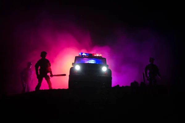 Anti-riot police give signal to be ready. Government power concept. Police in action. Smoke on a dark background with lights. Blue red flashing sirens. Dictatorship power. Selective focus