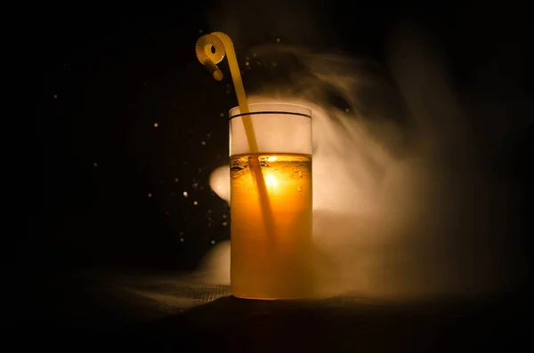 Cóctel verde amarillo brillante adornado con lima. Cócteles clásicos de alcohol, bebidas alcohólicas, refrescos, sabrosos cócteles sobre fondo oscuro con humo y luz — Foto de Stock