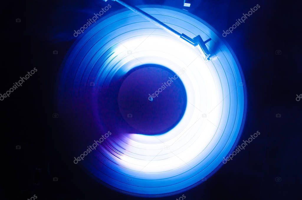 Concept of speed - Trail of fire and smoke - Vinyl record. Burning vinyl disk. Turntable vinyl record player. Retro audio equipment for disc jockey. Sound technology. Close up