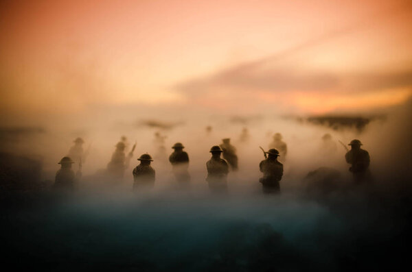 War Concept. Military silhouettes fighting scene on war fog sky background, World War Soldiers Silhouettes Below Cloudy Skyline At night. Attack scene. Armored vehicles. Tanks battle