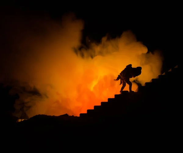 Una silueta de un hombre aferrado a la mujer. Concepto de rescate salvador. Escapar del fuego o el peligro. Reloj de arena, Fuego — Foto de Stock