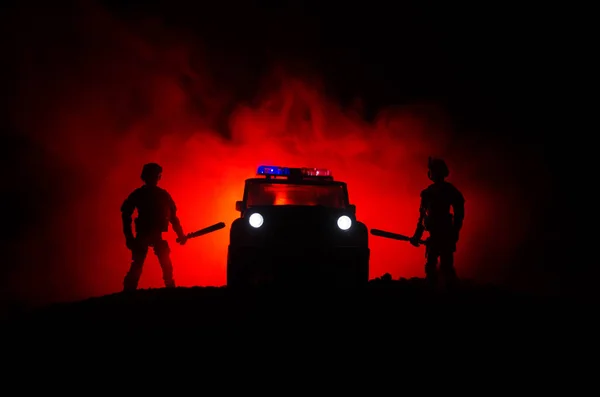 Anti-riot police give signal to be ready. Government power concept. Police in action. Smoke on a dark background with lights. Blue red flashing sirens. Dictatorship power. Selective focus — Stock Photo, Image