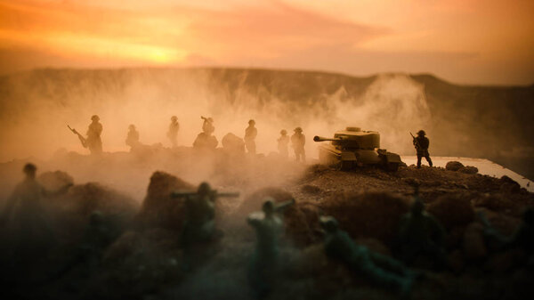 War Concept. Military silhouettes fighting scene on war fog sky background, World War Soldiers Silhouettes Below Cloudy Skyline At night. Attack scene. Armored vehicles. Tanks battle